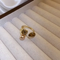 Close-up of elegant gold open ring featuring a luster pearl and brown faceted zircon stones - Champagne Zirconia Pearl Style (WR271) / Gold