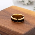 Macro detail of gold and black titanium ring featuring a temperature Celsius symbol - US 6 / Gold