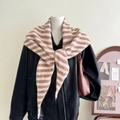 Detail of wool blend striped knit scarf draped as a shawl over a leather jacket - Khaki Striped
