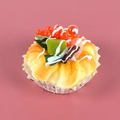 Realistic faux cake model with red berries and chocolate drizzle on a decorative paper tray - Red Grape