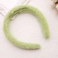 Close-up of soft light green plush headband on a decorative white textured background - Matcha Green (Faux Rabbit Fur)