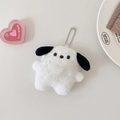 Close-up of a plush white puppy keychain with black ears on a beige surface - White Puppy