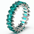 Detailed close-up of oval-cut green zircon stones set in 18k gold plated titanium ring - Silver + Aqua Green Zirconia