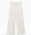 Detail showing high-waisted wide-leg trousers in cream with adjustable drawstring waist - S / Wide Leg Pants / White