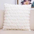 Detailed view of white plush heart-patterned cushion on sofa with elegant background - White