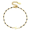 Detail of gold lightning bolt pendant on bohemian bead chain with lobster clasp - Gold-Black Beads