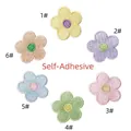 Macro view of six self-adhesive macaron flower embroidered patches in varied pastel colors - 6-Piece Set