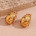Golden teardrop earrings with colorful zircon gemstones on a textured stone display - Gold Multicolor Zirconia (F802)