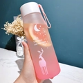 Pink frosted plastic water bottle with deer moon pattern and white lid held by hand - Upgraded PC Plastic / 500ml / Matte Pink