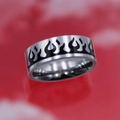 Close-up of titanium steel ring with black flame patterns on a red background - Eternal Flame Ring