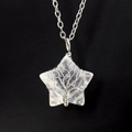 Macro shot of silver wire wrapped tree of life pattern on star shaped white crystal necklace - Silver & White Crystal