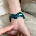 Close-up of irregular wave acrylic bangle in dark green with a glossy resin finish - 40# Bracelet-Dark Green Wave Streamline