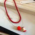 Double-layer necklace with red beads, silver chain, and apple pendants on display - Style 33 - Layered Apple Pendants