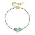 Macro detail of gold stainless steel bracelet featuring a blue heart enamel pendant - Sky Blue