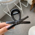 Close-up of a minimalist black bow hair claw clip made of durable resin material - Matte Black