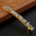 Macro shot of handmade gold wire hair clip with grey-blue natural raw crystal stones - Labradorite + Gold Clip