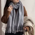 Classic heather grey cashmere feel scarf with fringe tassel worn with autumn winter outfit - Light Gray
