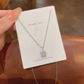Macro shot of a square halo pendant necklace featuring a brilliant round zircon stone - Classic Square Halo Necklace (X447) / Silver/Square Zirconia