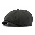 Classic black newsboy cap featuring herringbone texture and a small metal logo detail - One Size / Black