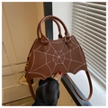 Detail of bat-shaped brown leather handbag with white spiderweb embroidery and metallic hardware - Coffee