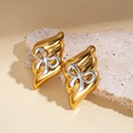 Detail of vintage gold textured earrings featuring a central silver bow design on stone - Gold