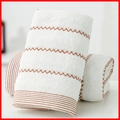 White cotton face towel with brown wavy patterns and textured plush pile finish - Cotton Wave Cream (Towel)