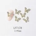 Macro shot of 11x9mm butterfly nail art charms with gold metal and zircon inlay - Gold Full Rhinestone Butterfly Style (7178)