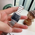Detail view of a square quartz watch with black dial and silver link chain strap - Silver/Black
