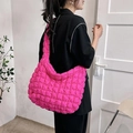 Bright pink quilted puffer tote bag shown on a model for a stylish oversized look - Rose Red