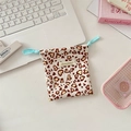 Detail of canvas drawstring pouch with leopard heart print on office desk scene - Corduroy Leopard Heart Beige