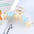 Detail of matte heart claw clip showing 3D cream and blue hearts on a translucent base - Blue + Creamy White Hearts