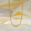 Close-up of golden twisted rope chain necklace on soft beige silk fabric background - 25【h1263】 3mm S-chain Necklace Gold