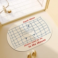 Beige oval bath mat with blue grid and quote Good ideas always come to me in the shower - 40*60cm / Bath Idea - Oval