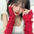 Close-up of red ribbed knit fingerless arm warmers with a stylish slouchy texture - Red