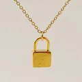 Gold padlock necklace featuring an engraved letter X on a minimalist square pendant - Letter X Style