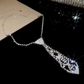 Detail of silver tie-shaped necklace with rhinestones and tassel in vintage court style - Silver Tie Style