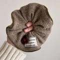 Taupe knitted oversized scrunchie with green trim and a brown crochet flower detail - Knit Flower Patch Coffee Scrunchie