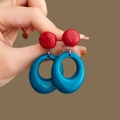 Detail view of red resin stud earrings with large blue hollow rings for women - 2# Silver Pin - Blue & Red (HE25012)
