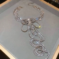 Macro detail of luxury layered fringe necklace with rhinestones and white pearls - Silver Rhinestone Bow Tassel Necklace