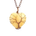 Macro detail of handmade wire-wrapped tree of life on heart-shaped natural crystal - Antique Copper + Yellow Topaz