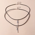 Detail of silver skeleton pendants on black cord necklaces with lobster clasp closures - 2 Skulls Necklace Set