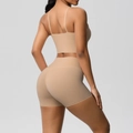 Macro detail of seamless nude two-piece yoga set with thin straps and high-waist shorts - Medium Khaki
