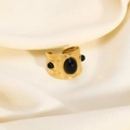 Detailed close-up of wide gold textured ring with three black gemstones on silk - Black Gemstone Style (YYR023115-BL)