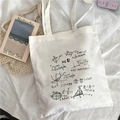 White canvas tote bag featuring black mathematical formulas print on a white bed sheet - Math Formulas X