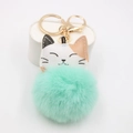 Close-up of mint green pompom keychain featuring a cute lucky cat face and golden clasp - Gold Buckle Cat / Mint Green
