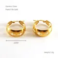 Detalle de pendientes de aro de 26mm en acero inoxidable dorado con cruces caladas - Oro de 18K / Dorado
