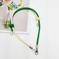 Macro view of dual-color leather phone lanyard with silver metal clasp and knots - Yellow & Green