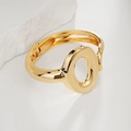 Polished gold geometric oval hollow bracelet with a hinged closure on a stone background - Oval Geometric Hollow Hinged Bangle (SL249) / Gold