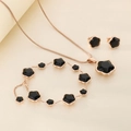 Detail of rose gold clover jewelry set with black enamel inlay and tassel accents - Short Stud 3-Piece Set / Rose Gold