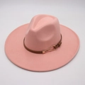 Detailed close-up of pink felt fedora hat featuring a brown leather belt with gold buckle - Nude Pink (Heart Buckle)
